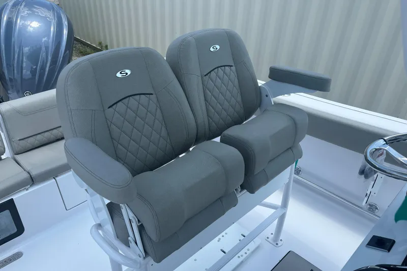 Slide: The Image of 2025 Sportsman Heritage 231 Center Console boat seats with diamond stitching and armrests. - 8