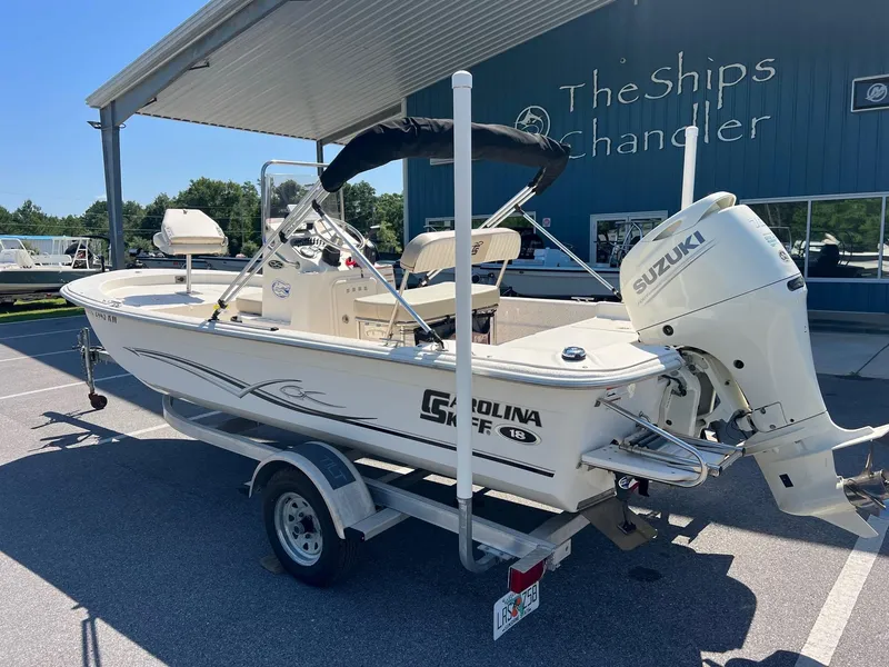 Slide: The Image of 2019 Carolina Skiff 18 JVX CC boat with Suzuki outboard motor on trailer. - 9