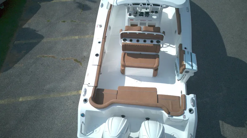 Slide: The Image of 2026 Sea Hunt Ultra 275 SE boat interior with brown seating and dual engines. - 10