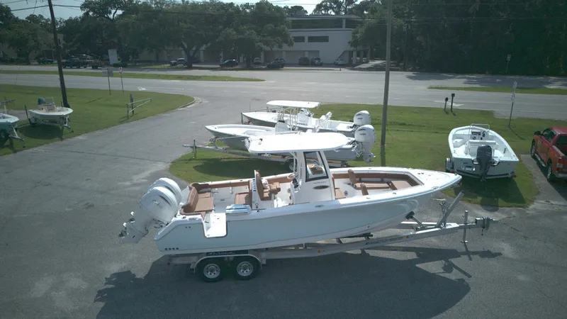 Slide: The Image of 2026 Sea Hunt Ultra 275 SE boat on trailer in outdoor dealership lot. - 13