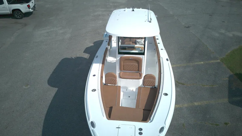 Slide: The Image of 2026 Sea Hunt Ultra 275 SE boat, aerial view, parked on asphalt. - 2