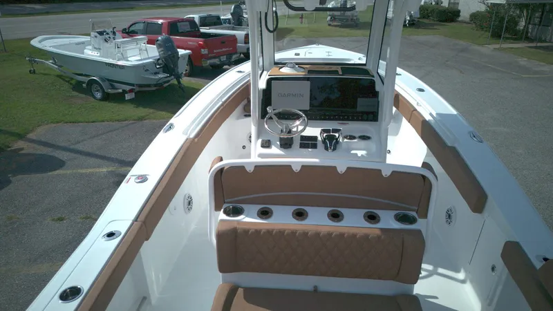 Slide: The Image of 2026 Sea Hunt Ultra 275 SE boat interior with helm, seating, and Garmin navigation system. - 8
