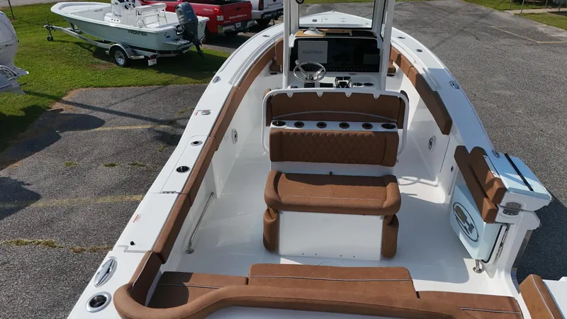 Slide: The Image of 2026 Sea Hunt Ultra 275 SE boat interior with brown seating and modern dashboard. - 9