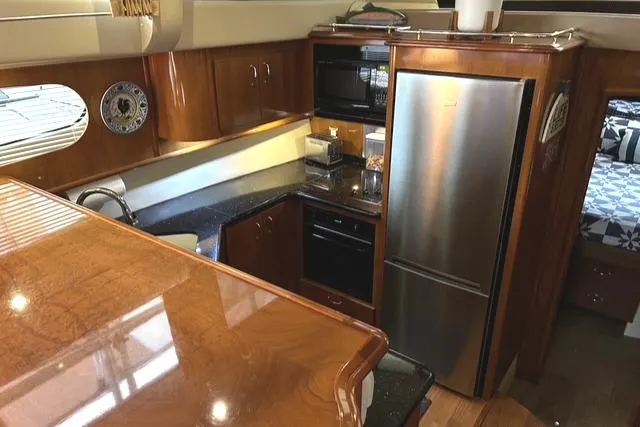 Slide: The Image of Interior of 2004 Carver 466 Motor Yacht with leather seating and entertainment area. - 13