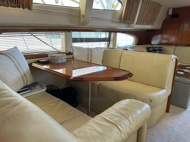 Slide: The Image of Luxurious kitchen interior of 2004 Carver 466 Motor Yacht with wood cabinetry and black countertop. - 15
