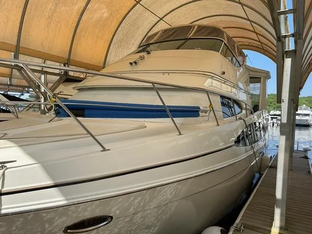 Slide: The Image of 2004 Carver 466 Motor Yacht on stands in a parking lot, side view. - 2