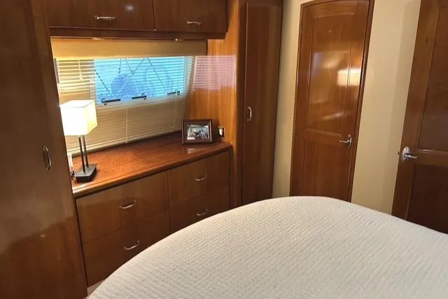 Slide: The Image of Interior of 2004 Carver 466 Motor Yacht with bed, portholes, and TV. - 21