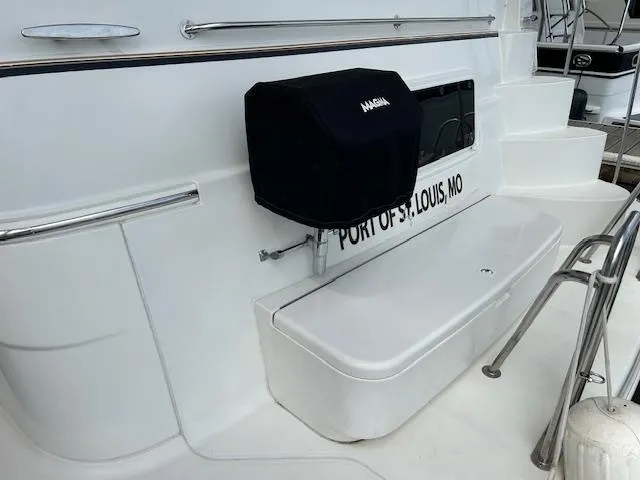 Slide: The Image of 2004 Carver 466 Motor Yacht deck with chairs, table, and water view. - 4