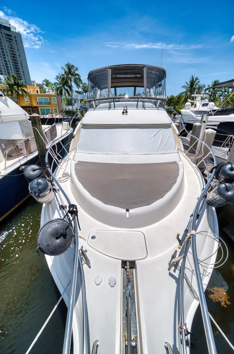 Slide: The Image of 2003 Silverton 43 Motor Yacht docked on a sunny day. - 10