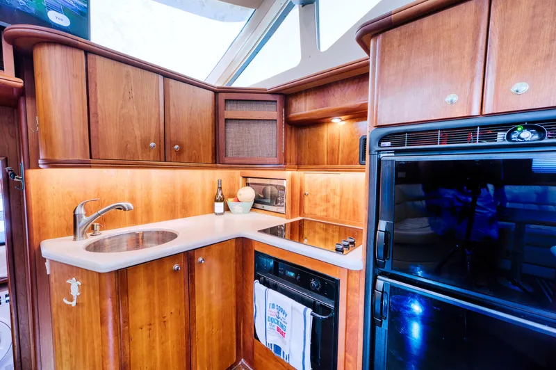 Slide: The Image of Interior of 2003 Silverton 43 Motor Yacht with TV and wood furnishings. - 39