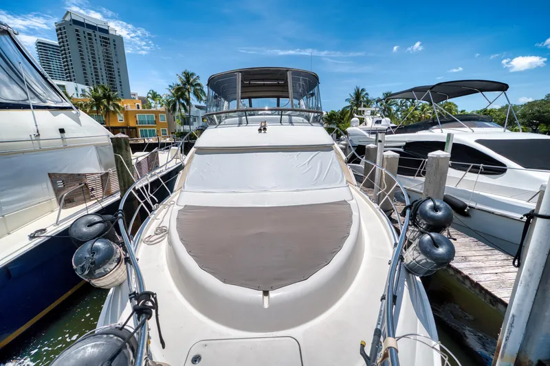 Slide: The Image of 2003 Silverton 43 Motor Yacht docked on a sunny day. - 9