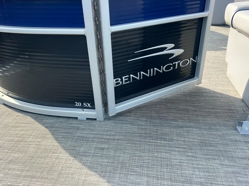 Slide: The Image of 2022 Bennington SX 20 Swingback pontoon boat, side view with logo and model details. - 11