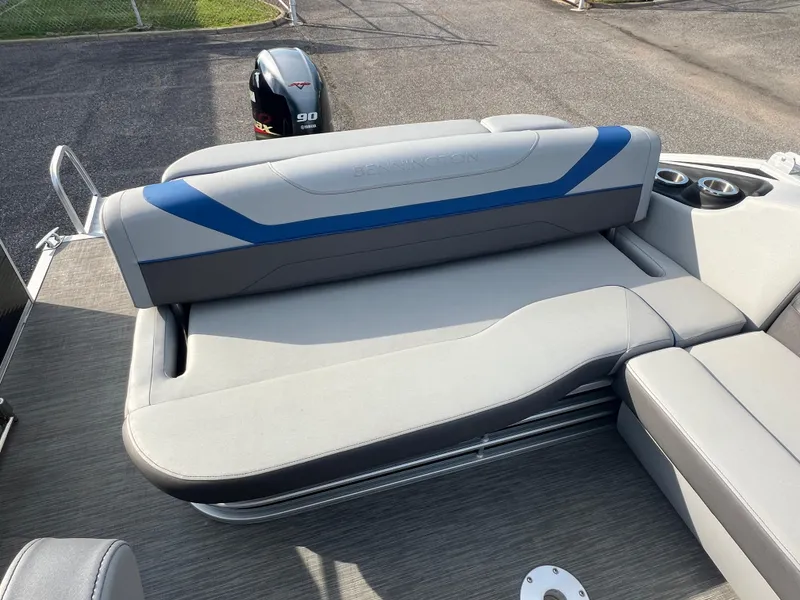 Slide: The Image of 2022 Bennington SX 20 Swingback boat interior with gray and blue seating. - 17