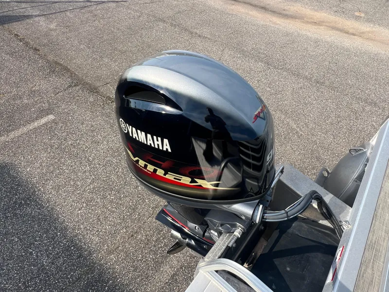 Slide: The Image of Yamaha outboard motor on 2022 Bennington SX 20 Swingback boat, parked on asphalt. - 20