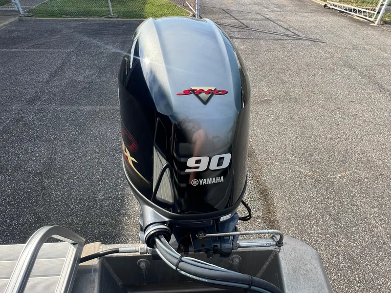 Slide: The Image of 2022 Bennington SX 20 Swingback with Yamaha 90 outboard motor on pavement. - 21