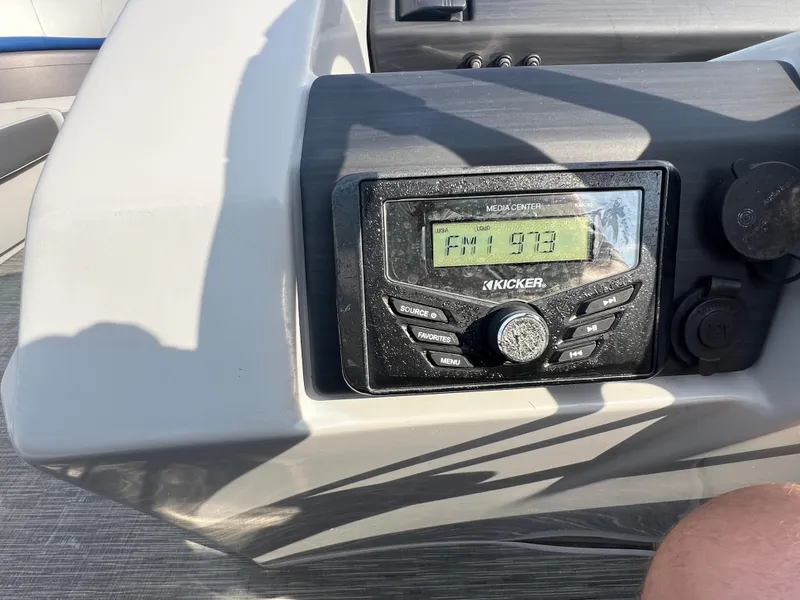 Slide: The Image of Boat dashboard with Kicker media center displaying FM 97.3, Bennington SX 20 Swingback 2022. - 30