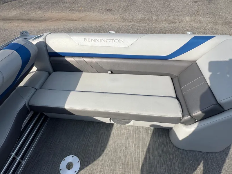 Slide: The Image of 2022 Bennington SX 20 Swingback boat interior with gray and blue seating. - 34