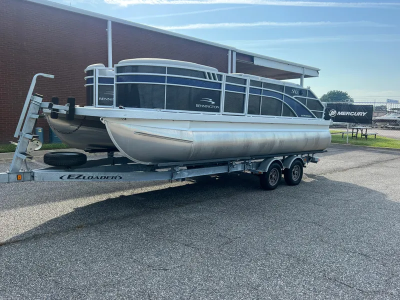 Slide: The Image of 2022 Bennington SX 20 Swingback pontoon boat on trailer, parked outdoors. - 8