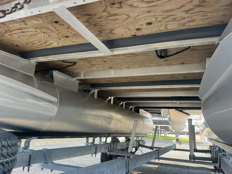 Slide: The Image of Underneath view of a 2022 Bennington SX 20 Swingback pontoon boat on a trailer. - 9
