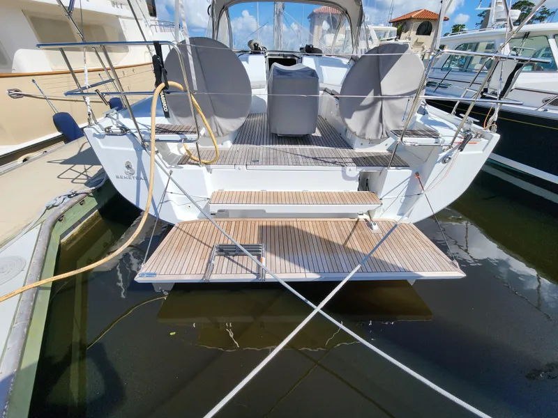 Slide: The Image of 2022 Beneteau Oceanis 40.1 yacht docked, showcasing rear deck and boarding steps. - 11