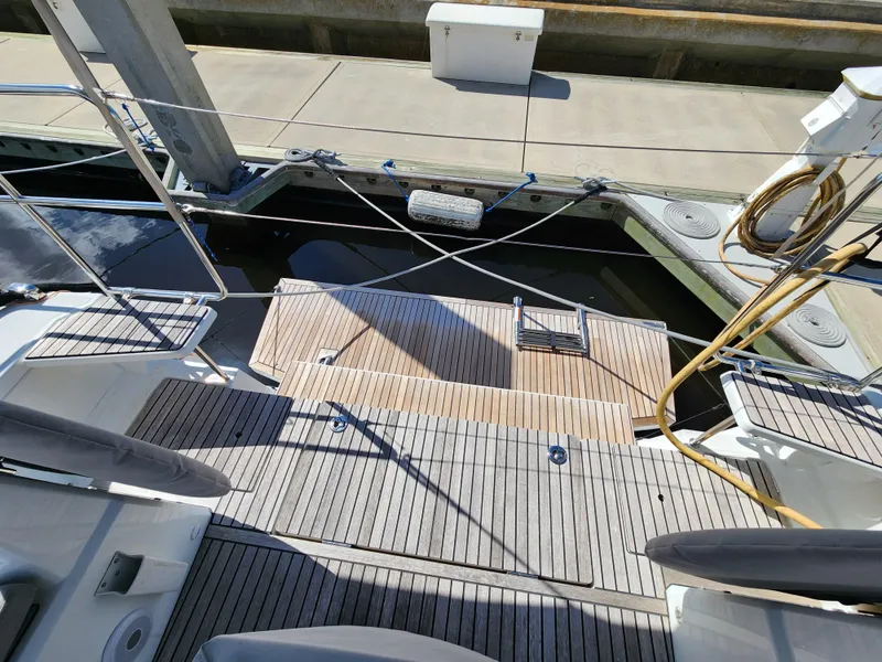 Slide: The Image of Beneteau Oceanis 40.1 yacht deck, 2022 model, docked at marina with wooden flooring. - 12