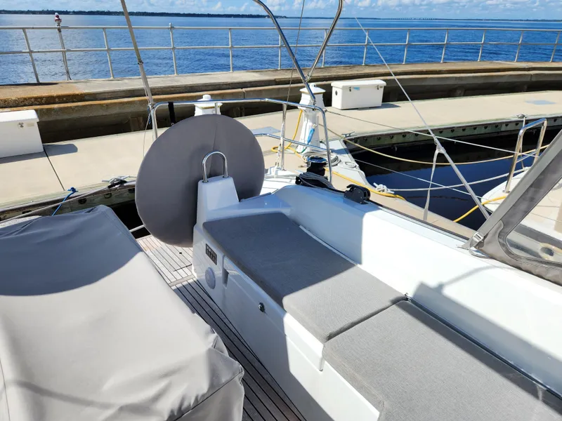 Slide: The Image of Beneteau Oceanis 40.1 yacht deck, 2022 model, docked at marina with clear blue water. - 21