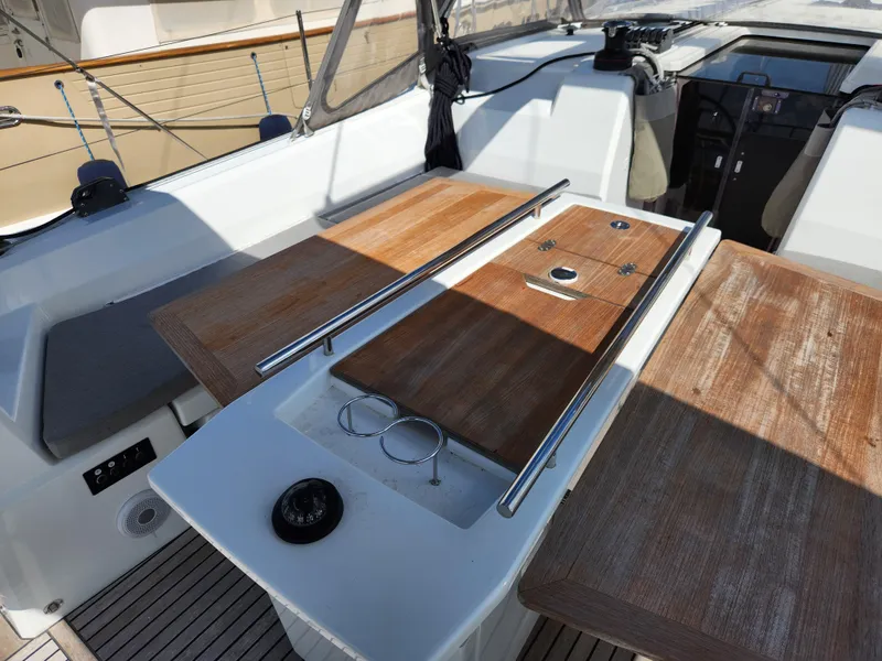 Slide: The Image of Cockpit of 2022 Beneteau Oceanis 40.1 sailboat with wooden table and seating. - 24