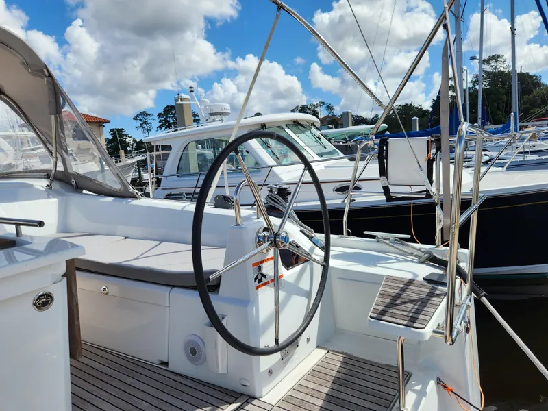 Slide: The Image of Beneteau Oceanis 40.1 sailboat cockpit with steering wheel, docked at marina, 2022 model. - 29