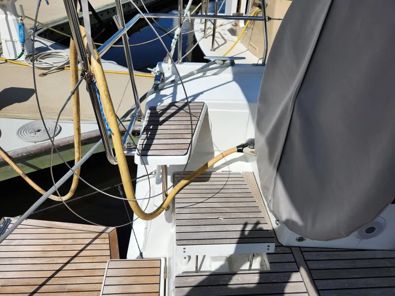 Slide: The Image of Beneteau Oceanis 40.1 yacht deck, 2022 model, featuring wooden steps and covered equipment. - 33