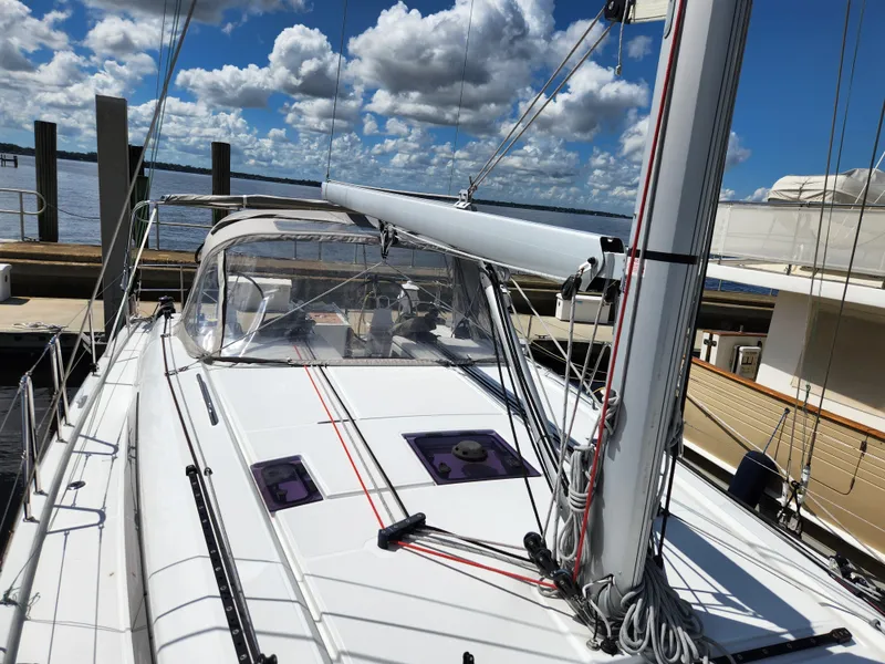 Slide: The Image of 2022 Beneteau Oceanis 40.1 sailboat docked under a cloudy sky. - 47