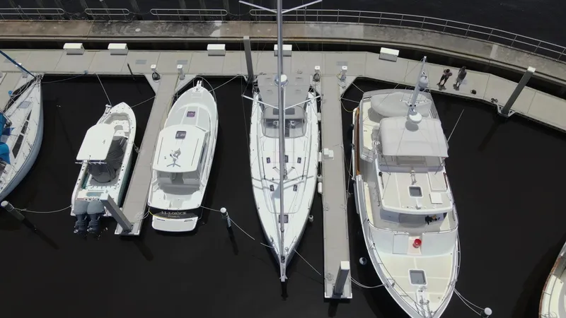 Slide: The Image of Aerial view of boats docked, featuring a 2022 Beneteau Oceanis 40.1 sailboat. - 5