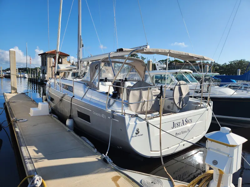 Slide: The Image of 2022 Beneteau Oceanis 40.1 yacht docked at marina under clear blue sky. - 9
