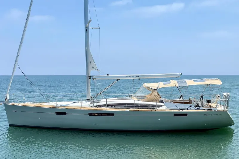 Slide: The Image of 2018 Jeanneau 58 sailboat on calm sea under clear blue sky. - 0