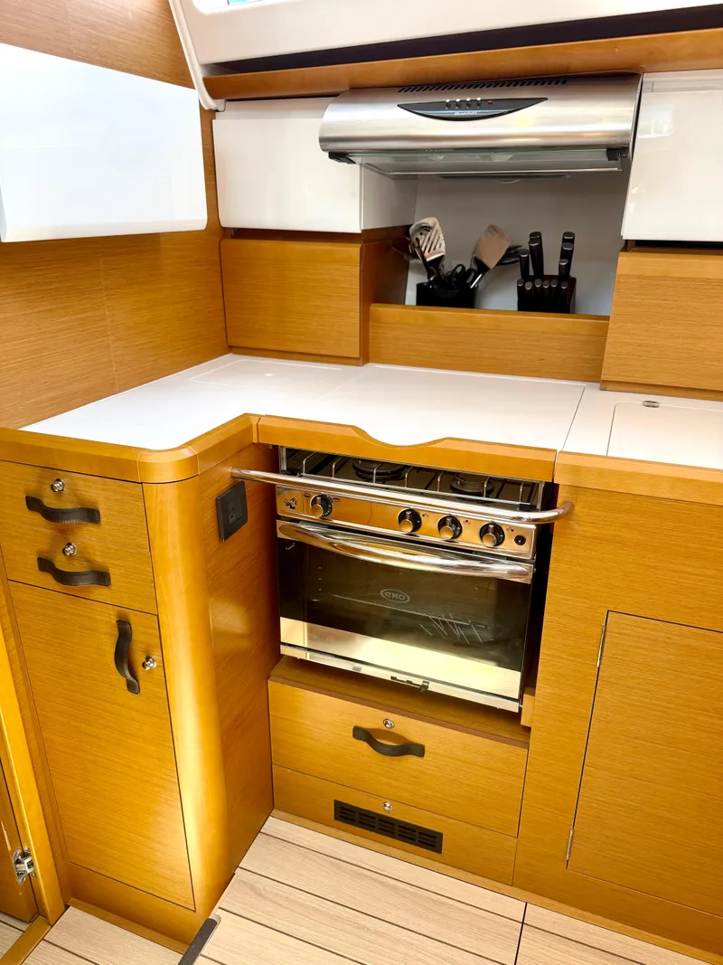 Slide: The Image of Modern kitchen in 2018 Jeanneau 58 yacht with wooden cabinetry and stainless steel oven. - 11