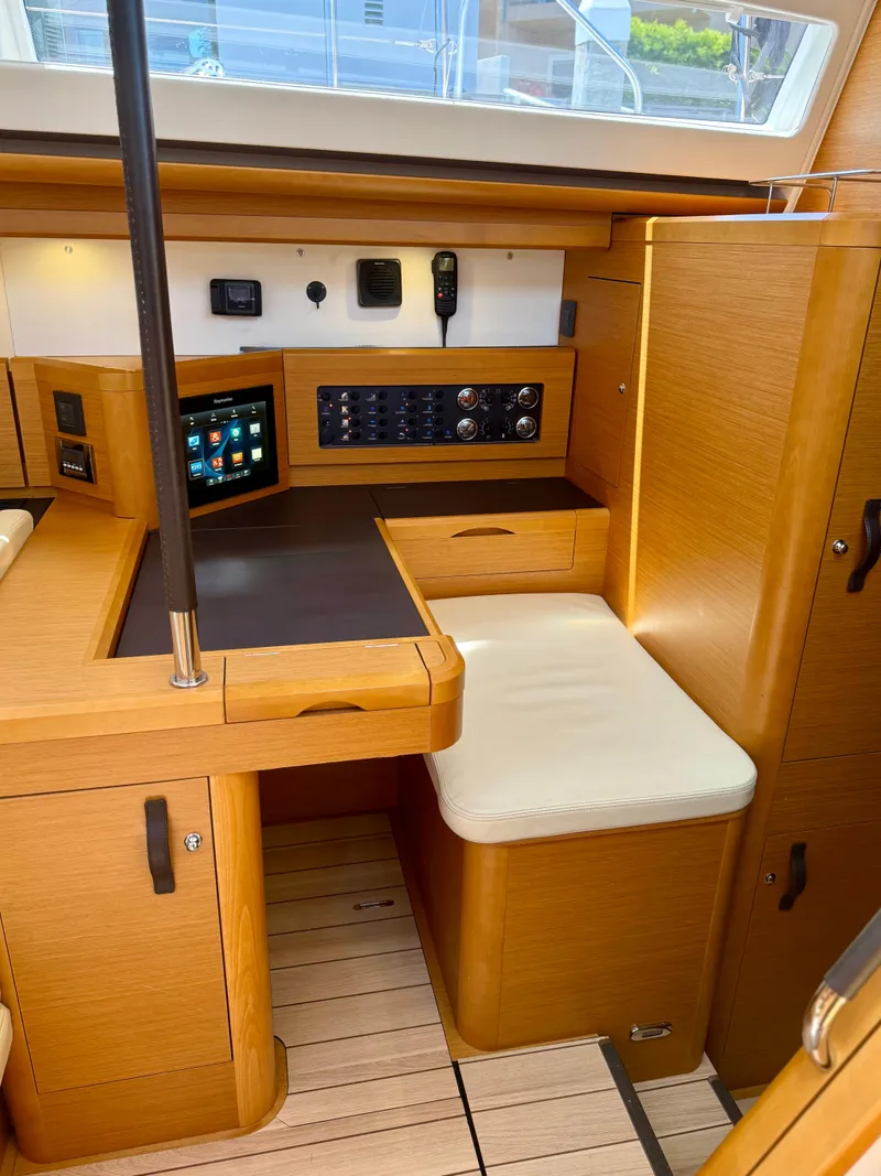 Slide: The Image of 2018 Jeanneau 58 yacht interior with navigation station and control panel. - 15