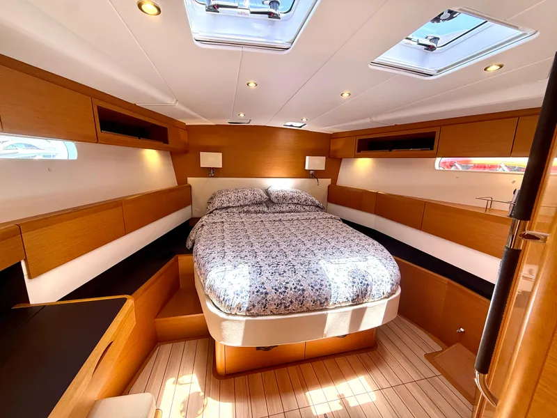 Slide: The Image of Luxurious cabin interior of 2018 Jeanneau 58 yacht with cozy bed and wooden finish. - 17