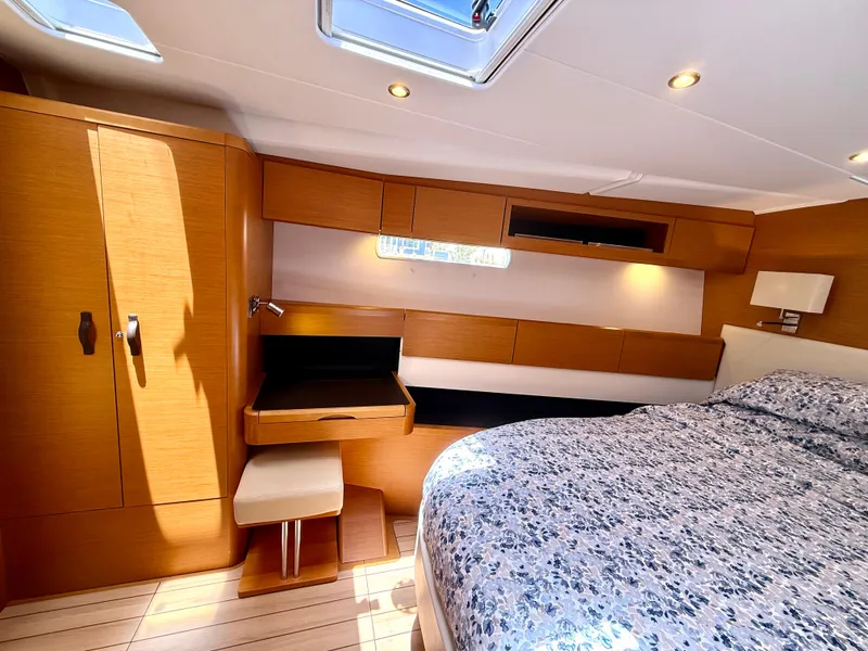 Slide: The Image of Luxurious cabin interior of 2018 Jeanneau 58 yacht with wooden furnishings and skylight. - 18