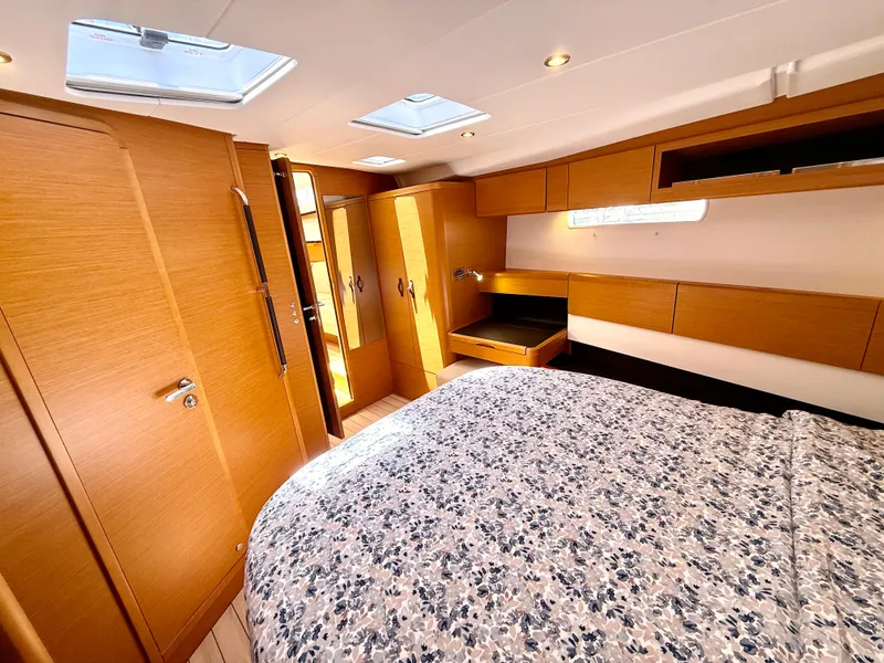 Slide: The Image of Luxurious interior of 2018 Jeanneau 58 yacht with wood finish and floral bedding. - 19