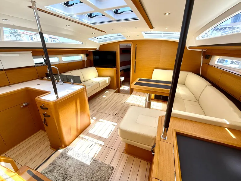 Slide: The Image of Luxurious interior of 2018 Jeanneau 58 yacht with modern furnishings and ample natural light. - 2