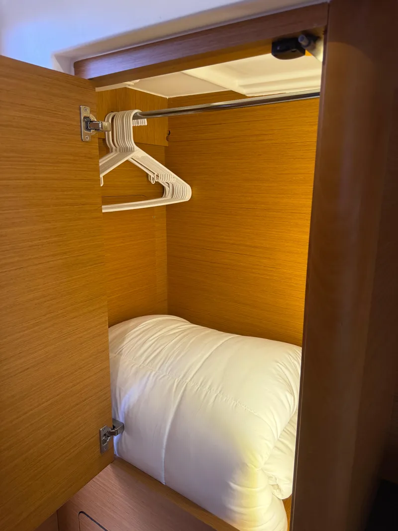 Slide: The Image of Wooden closet with hangers and bedding inside Jeanneau 58, 2018 model. - 23