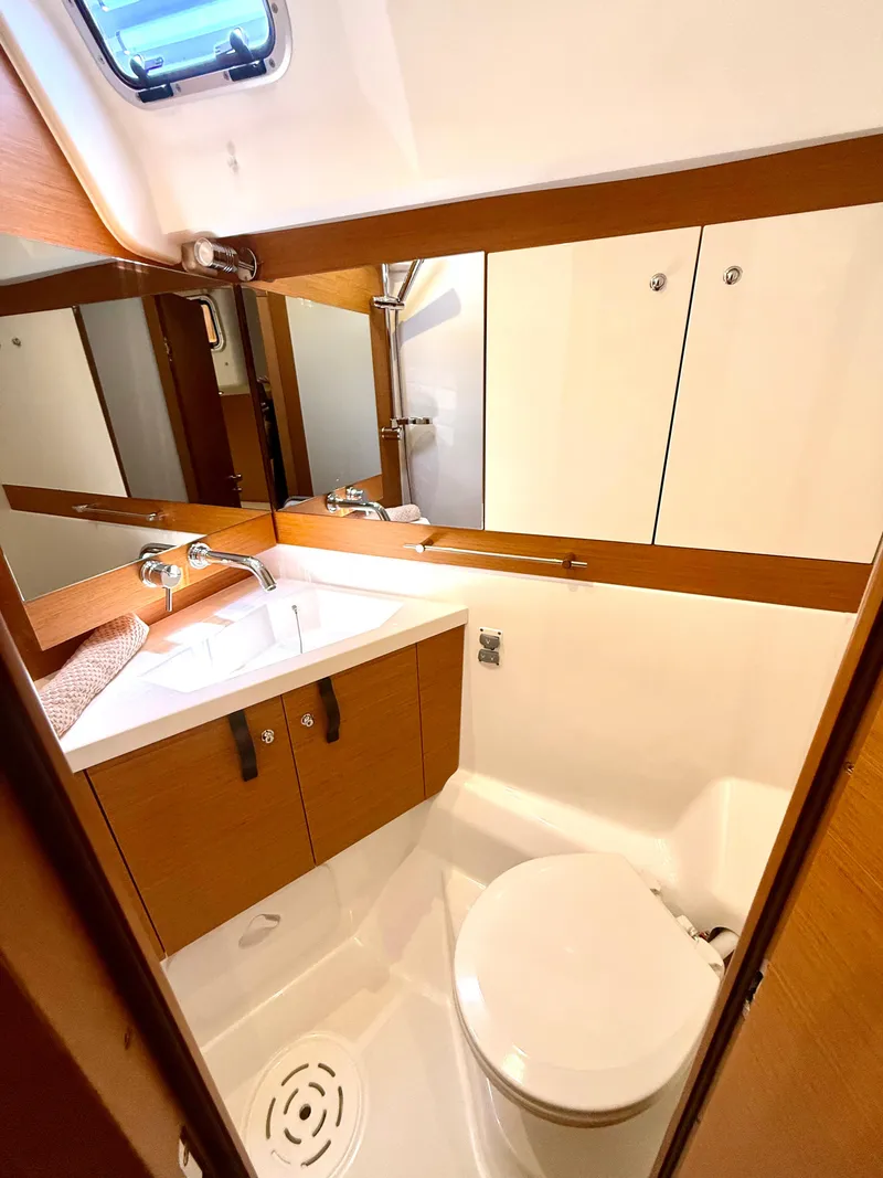 Slide: The Image of Luxurious bathroom in 2018 Jeanneau 58 yacht, featuring modern fixtures and wooden cabinetry. - 24