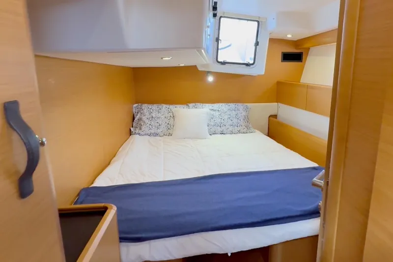 Slide: The Image of Cozy cabin interior of 2018 Jeanneau 58 yacht with bed and window. - 25