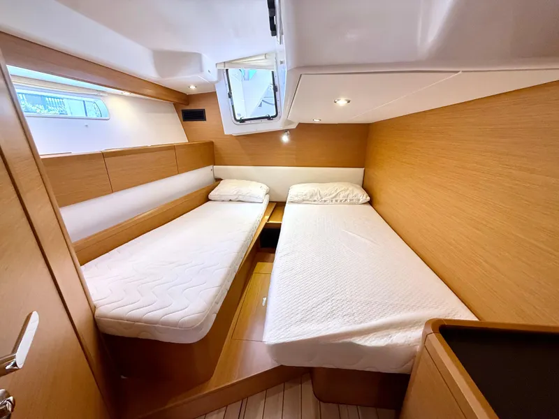 Slide: The Image of Luxurious cabin interior of 2018 Jeanneau 58 yacht with twin beds and wooden finish. - 26