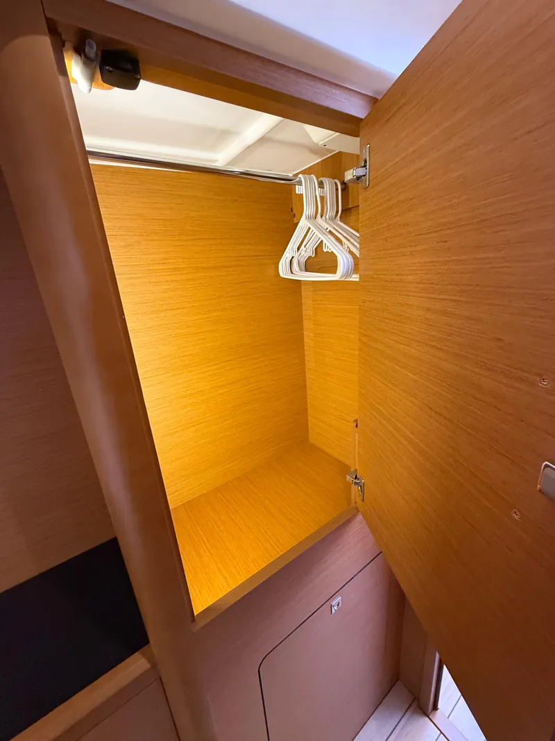 Slide: The Image of Wooden closet interior with hangers on a Jeanneau 58 yacht, 2018 model. - 28