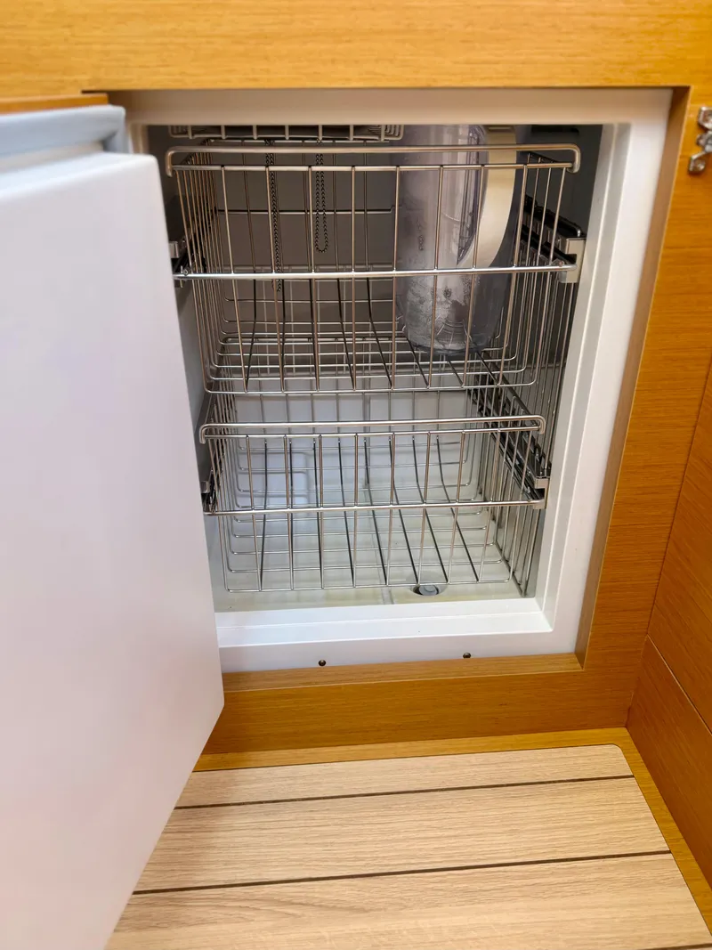 Slide: The Image of Open refrigerator with wire shelves on Jeanneau 58 yacht, 2018 model. - 29