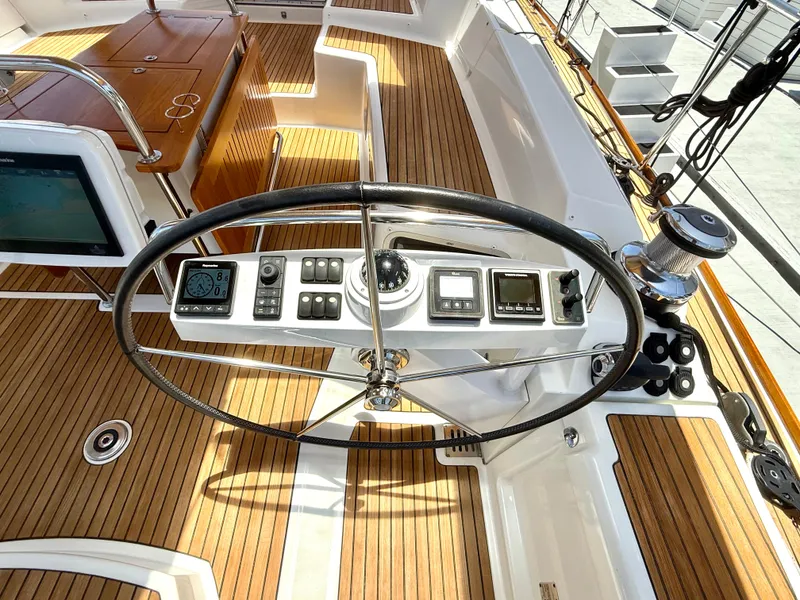 Slide: The Image of Steering wheel and controls of a 2018 Jeanneau 58 yacht with teak decking. - 30