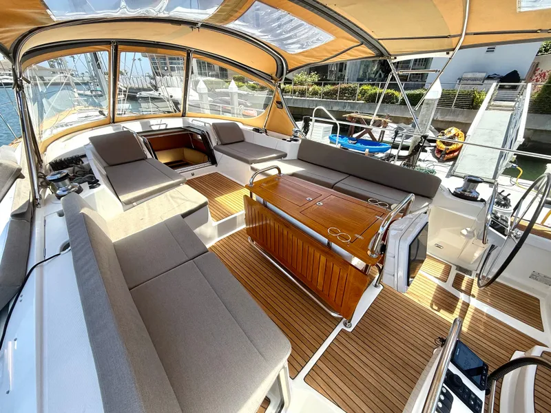 Slide: The Image of Luxurious 2018 Jeanneau 58 yacht cockpit with elegant seating and wooden table. - 37