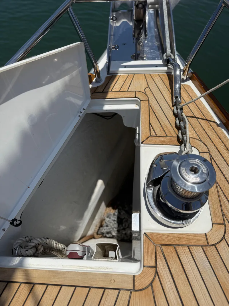 Slide: The Image of Anchor locker and windlass on 2018 Jeanneau 58 yacht deck. - 42