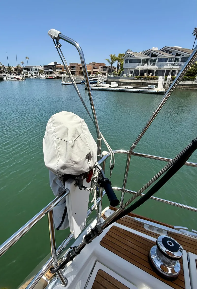 Slide: The Image of Jeanneau 58 sailboat deck view, 2018 model, overlooking marina with waterfront homes. - 48