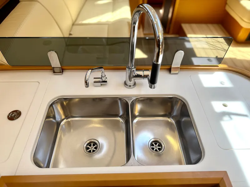 Slide: The Image of Modern kitchen sink in 2018 Jeanneau 58 yacht, featuring dual basins and sleek faucet design. - 9